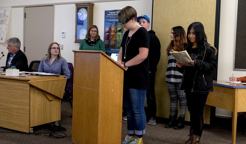 Students presenting their research to the school board.